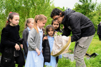 Aaron Bhambra, a Natural Prospects Trainee with Birmingham and Black Country Wildlife Trust, engaging with school group